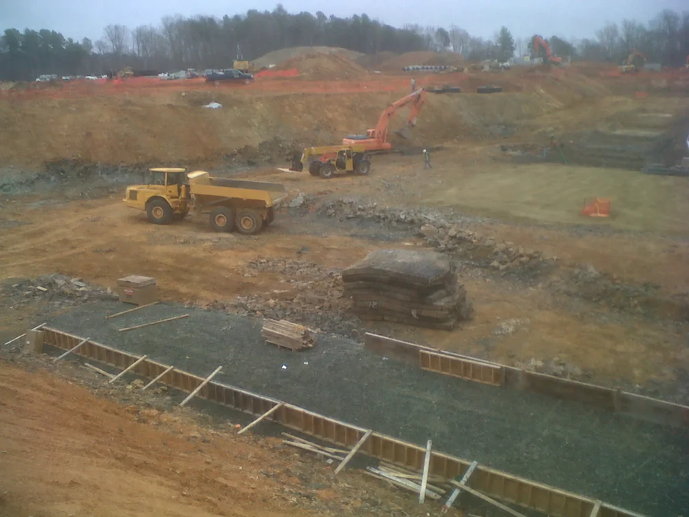 Haul truck and excavator in a large excavation; earthmoving example