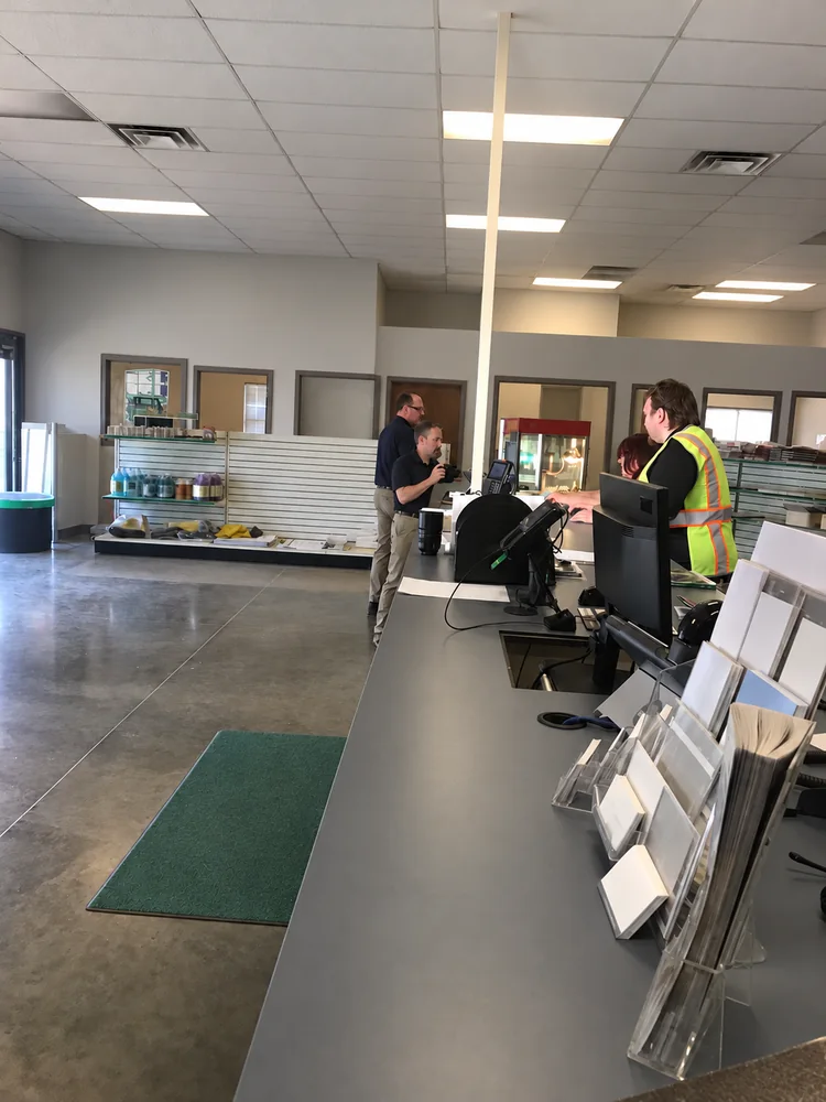 People at an unbranded equipment rental counter